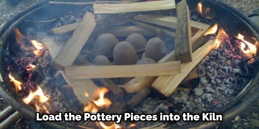 Load the Pottery Pieces into the Kiln