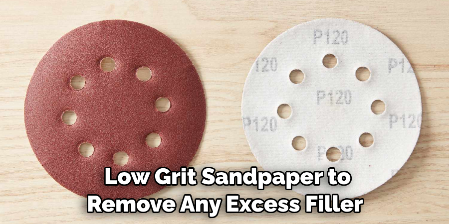 Low Grit Sandpaper to Remove Any Excess Filler